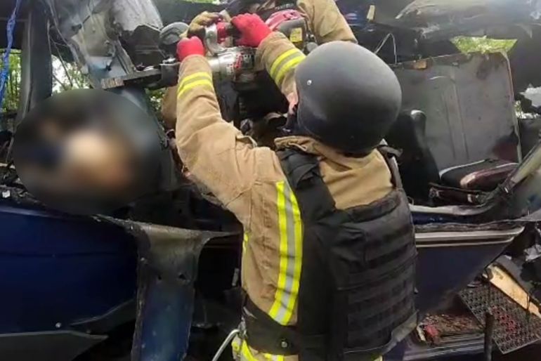 SUMY, UKRAINE - MAY 17: (EDITOR'S NOTE: Parts of this image have been blurred by the source) (----EDITORIAL USE ONLY - MANDATORY CREDIT - 'UKRAINIAN STATE EMERGENCY SERVICE / HANDOUT' - NO MARKETING NO ADVERTISING CAMPAIGNS - DISTRIBUTED AS A SERVICE TO CLIENTS----) Emergency officers carry out rescue operations after a Russian strike on a van in the Bilopillia city of Sumy Oblast resulted in the death of at least nine civilians and the injury of seven others, in Ukraine on May 17, 2025. Emergency responders used specialized equipment to cut through the wreckage of targeted van to recover the bodies of deceased civilians. (Photo by State Emergency Service of Ukraine/Anadolu via Getty Images)