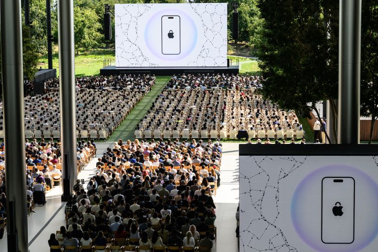 8-1749503501 Attendees watch a presentation during the annual Apple "Worldwide Developers Conference" (WWDC) at Apple Park, the corporate headquarters of Apple Inc., in Cupertino, California on June 9, 2025. Pressure is on Apple to show it hasn't lost its magic despite broken promises to ramp up iPhones with generative artificial intelligence (GenAI) as rivals race ahead with the technology. Apple will showcase plans for its coveted devices and the software powering them at its annual Worldwide Developers Conference (WWDC) kicking off Monday in Silicon Valley and running through June 13. (Photo by Josh Edelson / AFP)