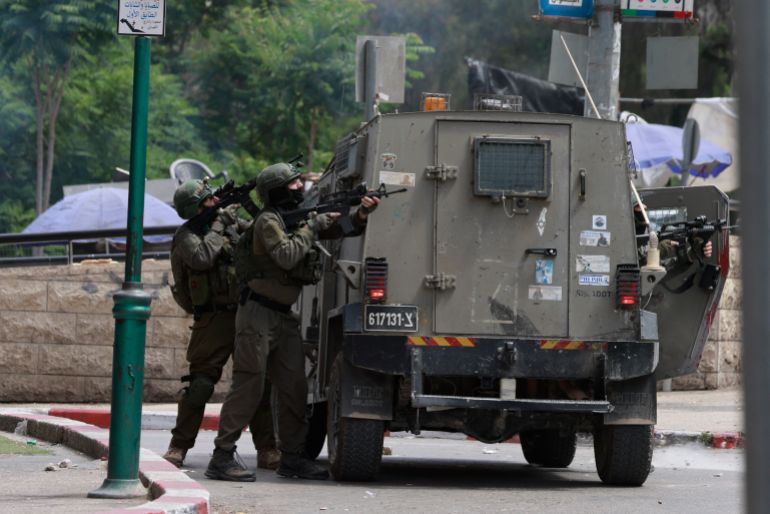 afp_68399d0bd343-1748606219-1 Israeli army soldiers take position during a raid in the heart of the Palestinian city of Nablus, in the occupied West Bank on May 27, 2025.