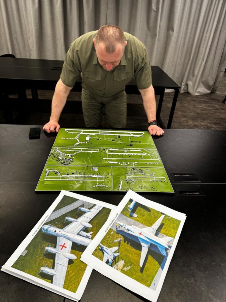 afp_683cb070e6ea-1748807792-1 This undated and unlocated handout picture, released on June 1, 2025 by the Security Service of Ukraine shows Head of Ukraine’s Security Service Vasyl Malyuk looking at a map showing a Russian military aircraft base, amid the Russian invasion of Ukraine.