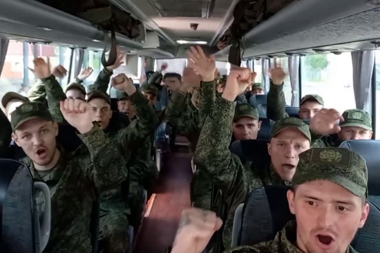 In this video grab taken from a handout footage released by the Russian Defence Ministry on June 9, 2025, Russian prisoners of war (POWs) react sitting in a bus following an exchange at an undisclosed location in Belarus.