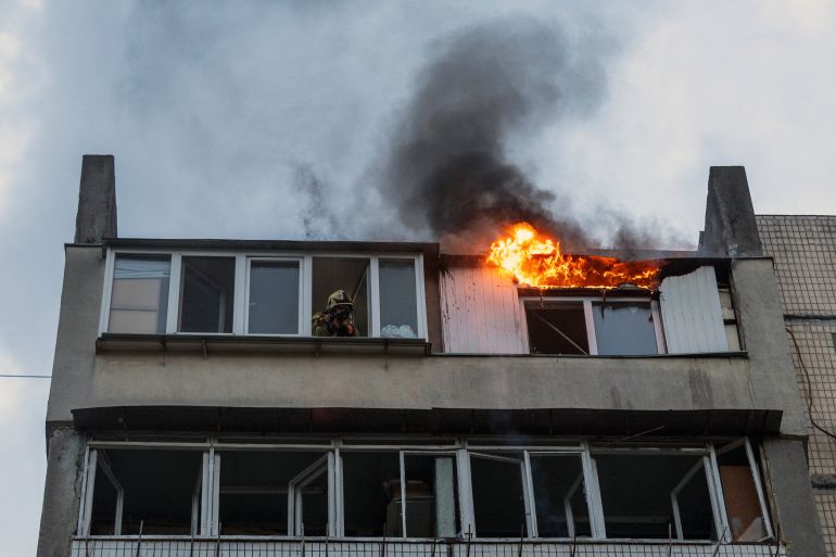 Flames burst from an apartment building damaged during a Russian drone strike, amid Russia's attack on Ukraine, in Kyiv, Ukraine, May 24, 2025. REUTERS/Thomas Peter