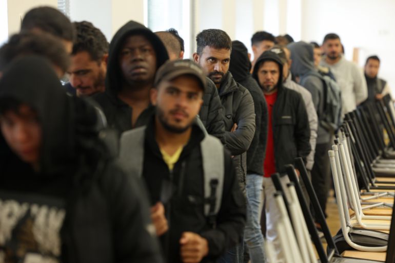 EISENHUETTENSTADT, GERMANY - OCTOBER 05: Men, many of them from Syria, queue for lunch at the initial reception facility for migrants and refugees on October 05, 2023 in Eisenhuettenstadt, Germany. The Eisenhuettenstadt facility serves as both a registration center and a temporary shelter for newly-arrived asylum seekers in the eastern state of Brandenburg. Germany is struggling to cope with a current large influx of migrants, mainly from Syria, Afghanistan and Turkey, arriving via Poland and the Czech Republic. (Photo by Sean Gallup/Getty Images)