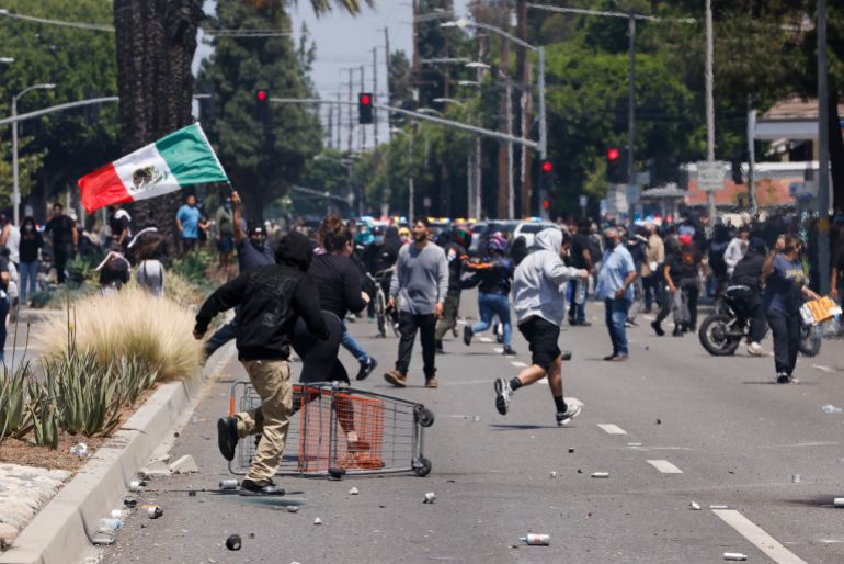 Los Angeles, CA - June 07: Anti-ICE protesters flee tear gas and flash bang grenades fired by ICE officers on E Alondra Blvd. on Saturday, June 7, 2025 in Los Angeles, CA. (Carlin Stiehl / Los Angeles Times via Getty Images)