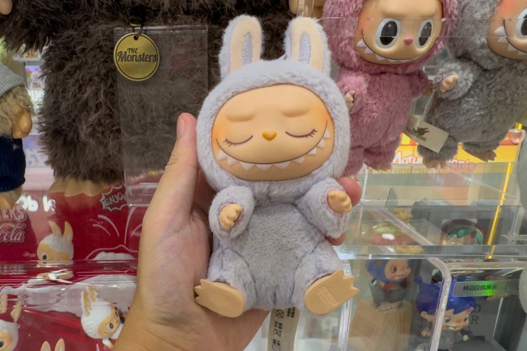 gettyimages-2218602191-1749207671 SHENZHEN, CHINA - JUNE 04: Labubu doll is on sale at a Pop Mart store on June 4, 2025 in Shenzhen, Guangdong Province of China. Labubus are small monster-like toys sold by Chinese retailer Pop Mart, which are sold in "blind boxes", so the buyer doesn't know what color or design the doll has until the box is opened. (Photo by VCG/VCG via Getty Images)