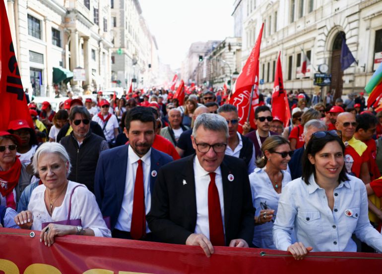 2025-italy-1758191384 Maurizio Landini, General Secretary of CGIL union and Secretary of the Italian Democratic Party Elly Schlein attend a May Day demonstration organized by confederate trade unions in Rome, Italy, May 1, 2025. REUTERS/Yara Nardi