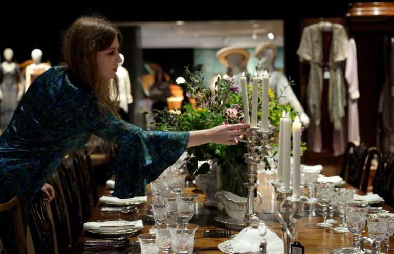 A gallery assistant poses with a set design used in the tv series Downton Abbey, during a press preview for the Downton Abbey farewell exhibition and an auction of props, costumes, and set pieces at Bonham’s in London, Britain, August 18, 2025. REUTERS/Hannah McKay