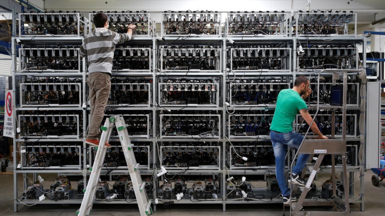 Employees work on bitcoin mining computers at Bitminer Factory in Florence, Italy, April 6, 2018. Picture taken April 6, 2018. REUTERS/Alessandro Bianchi