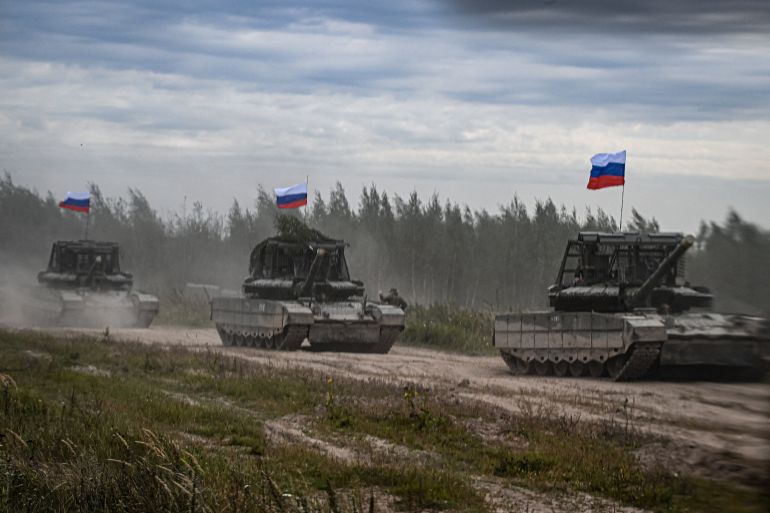 Russian tanks move during the "Zapad-2025" (West-2025) joint Russian-Belarusian military drills at a training ground near the town of Borisov, east of the capital Minsk, on September 15, 2025. (Photo by Olesya KURPYAYEVA / AFP)