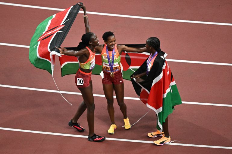 Kenya's Nelly Chepchirchir, Kenya's Faith Kipyegon and Kenya's Dorcus Ewoi celebrate after the women's 1500m final during the World Athletics Championships in Tokyo on September 16, 2025. (Photo by Philip FONG / AFP)