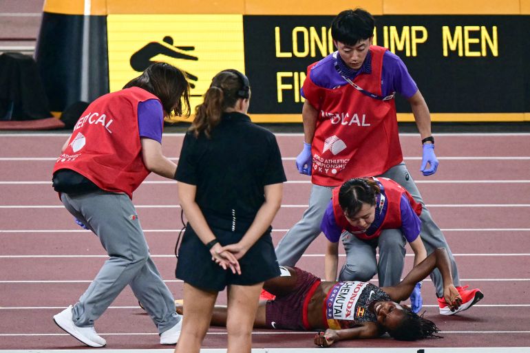 afp_68cbafb00785-1758179248 Uganda's athlete Peruth Chemutai (bottom) reacts as she gets medical attention after competing in the women's 3000m steeplechase final during the World Athletics Championships in Tokyo on September 17, 2025. (Photo by Yuichi YAMAZAKI / AFP)