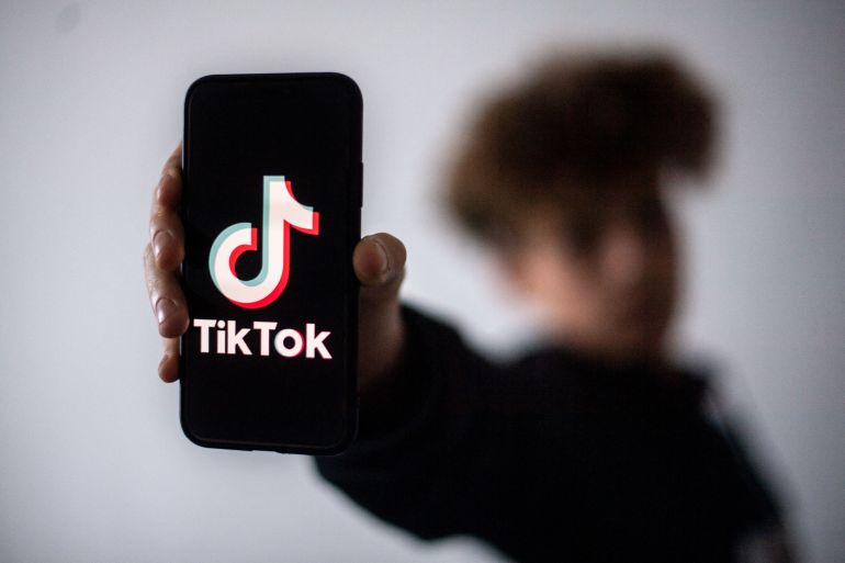 (FILES) A teenager presents a smartphone with the logo of Chinese social network Tik Tok, on January 21, 2021 in Nantes, western France.