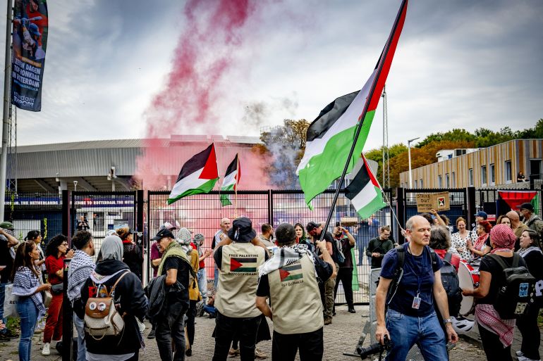 afp_68cee396d5e2-1758389142 Protesters, some holding up the Palestinian flag, gather to protest against Israel's offensive on the Gaza strip, at the Neptunus station before the Israel-France baseball game during the 2025 European Baseball Championship, in Rotterdam on September 20, 2025. (Photo by Robin Utrecht / ANP / AFP) / NETHERLANDS OUT