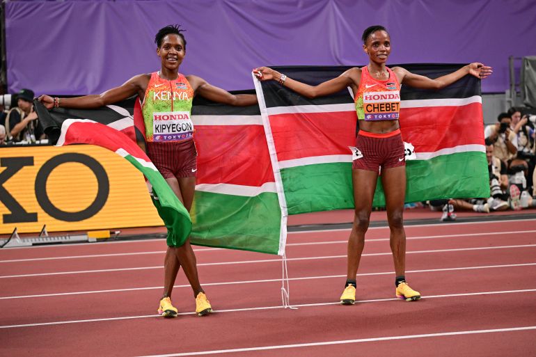 Silver medallist Kenya's athlete Faith Kipyegon and Gold medallist Kenya's athlete Beatrice Chebet celebrate after the women's 5000M final during the World Athletics Championships in Tokyo on September 20, 2025.