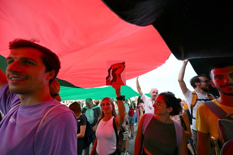 People march with a giant Palestinian flag during a nationwide strike "Let's Block Everything" in solidarity with Palestinians in Gaza and calling for a halt to arms shipments to Israel, in Rome on September 22.