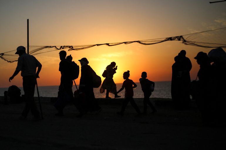 Displaced Palestinians move with their belongings southwards on a road in the Nuseirat refugee camp area in the central Gaza Strip on September 23, 2025, as Israel presses its ground offensive to capture Gaza City amidst the war against Hamas.