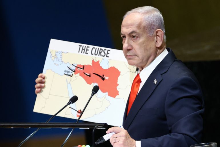 Israeli Prime Minister Benjamin Netanyahu holds a map as he speaks during the General Debate of the United Nations General Assembly at UN headquarters in New York City on September 26, 2025. (Photo by CHARLY TRIBALLEAU / AFP)