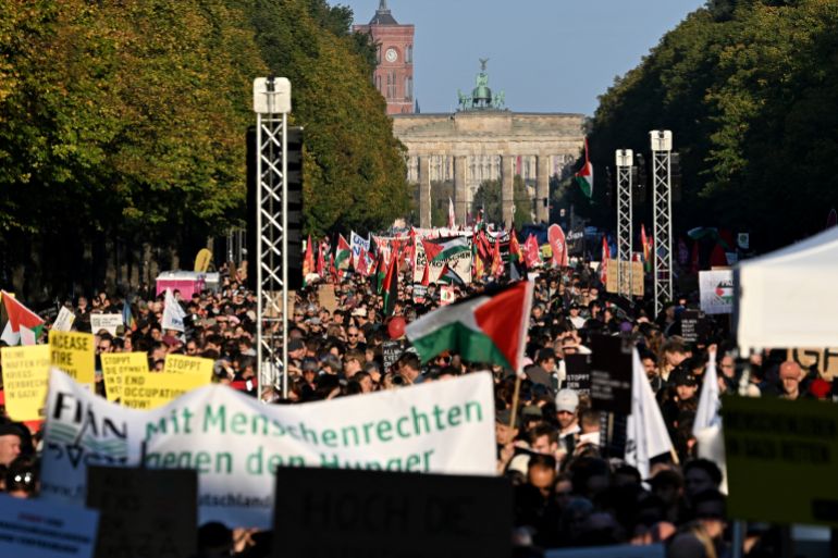Participants march with Palestinian flags during a demonstration under the motto 'Draw the red line with us: Together for Gaza!' near the Brandenburg Gate in the center of Berlin on September 27, 2025.