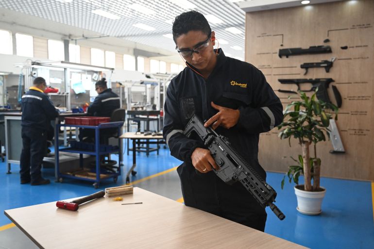 An engineer shows a new rifle designed and manufactured in the country by INDUMIL (Military Industry) at the Jose Maria Cordova Arms and Ammunition Factory in Soacha municipality, near Bogota on September 29, 2025.