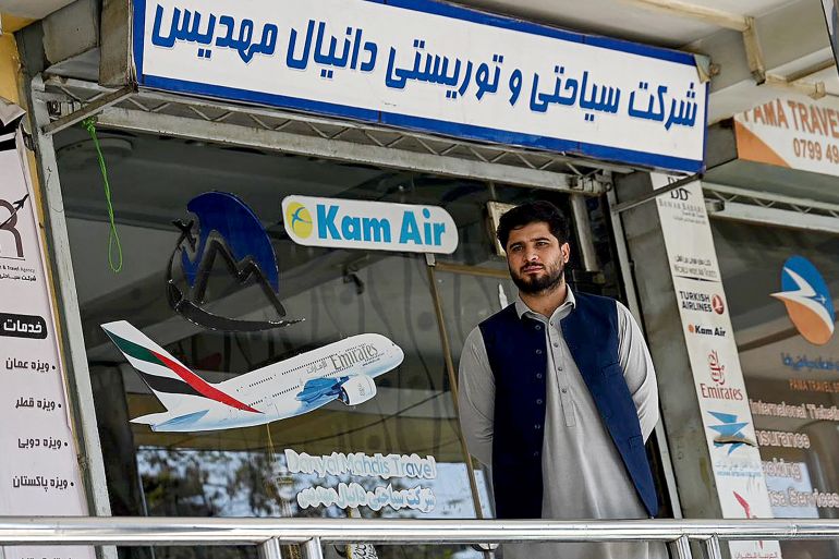 An Afghan employee from a travel agency stands outside his office amid a nationwide telecom outage in Kabul on September 30, 2025.