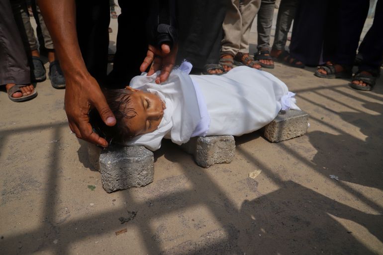 ap_68a98f5fda750-1755942751 The body of 5-year-old Jamal al-Najjar is placed on the ground atop bricks before a funeral prayer after he died at Nasser Hospital in Khan Younis, southern Gaza Strip, Tuesday, Aug. 12, 2025. The head of Nasser's pediatrics unit said Jamal, who was born with rickets, died from severe malnutrition. (AP Photo/Mariam Dagga)
