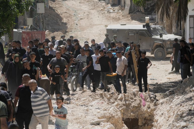 ap_68cbb6478a24f-1758180935 Residents of the West Bank urban refugee camp of Tulkarm evacuate their homes and carry their belongings as the Israeli military continues its operation in the area ahead of planned home demolitions by Israeli security forces, Sunday, July 6, 2025. (AP Photo/Majdi Mohammad)