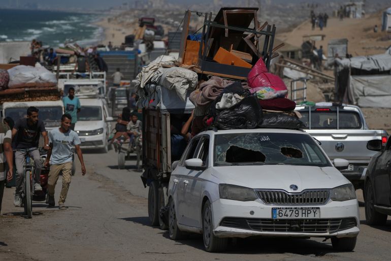 Displaced Palestinians flee northern Gaza Strip, by foot and in vehicles, carrying their belongings along the coastal road, near Wadi Gaza, Monday, Sept. 22, 2025. (AP Photo/Abdel Kareem Hana)