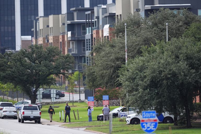Police gather near an apartment building close to a U.S. Immigration and Customs Enforcement office after a shooting, in Dallas on Wednesday, Sept. 24, 2025. (AP Photo/Julio Cortez)