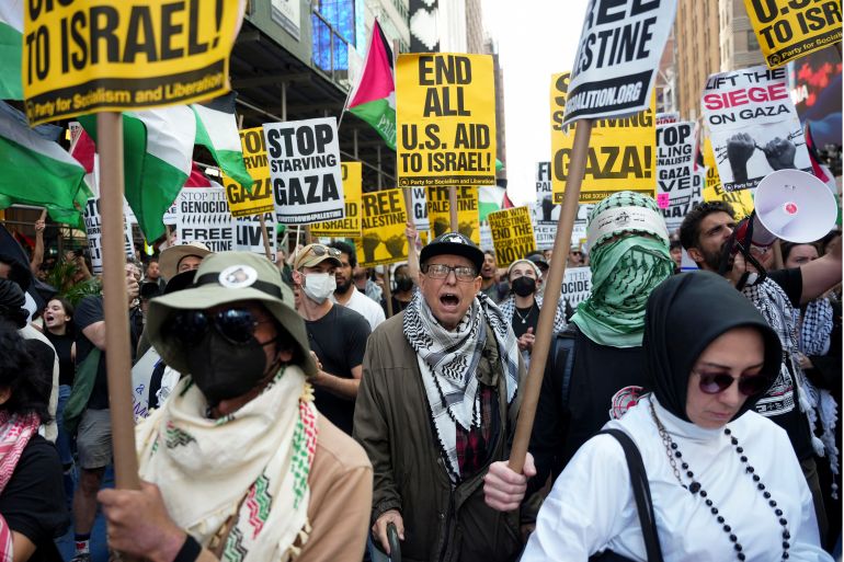John Robinson demonstrates with others in Times Square during a pro-Palestinian demonstration, Friday, Sept. 26, 2025, in New York. (AP Photo/Angelina Katsanis)