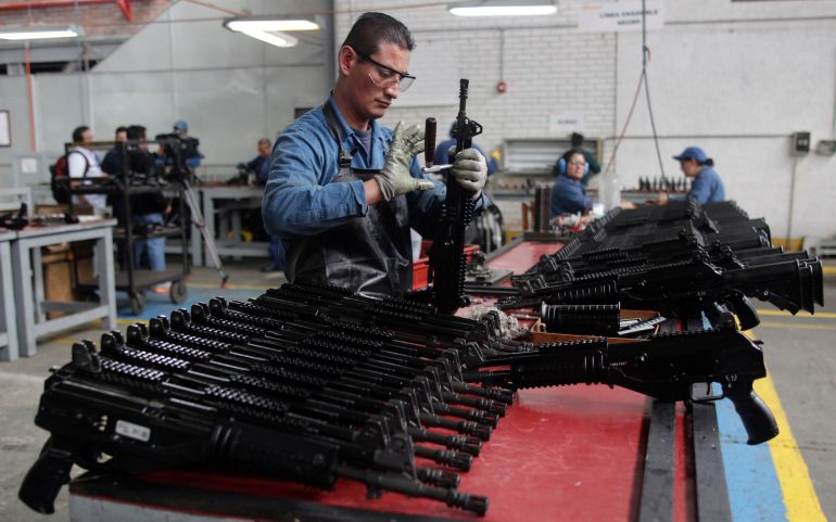 A worker assembles an assault rifle at the Colombian based military weapons manufacturer, Indumil, in Soacha, Colombia. Indumil is expected to launch the 9 mm pistol in June. (AP Photo/Fernando Vergara)