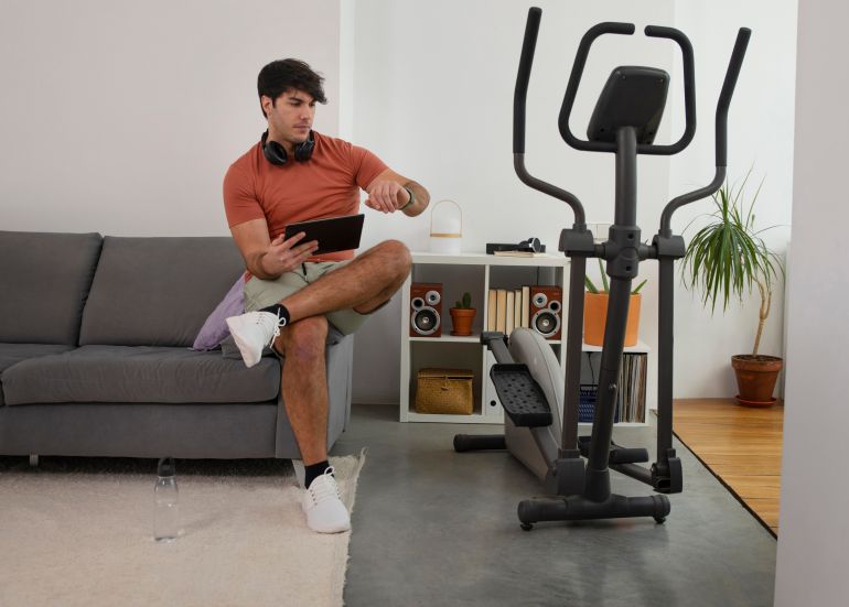 asdasdsad2-1759154840 Full shot man with exercise bike at home freepik