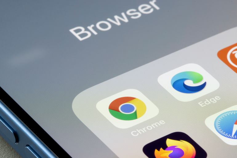 Portland, OR, USA - Dec 13, 2021: Google Chrome app is seen on an iPhone next to Edge and other web browser apps. Microsoft is using new prompts in Edge to try and stop users from downloading Chrome.