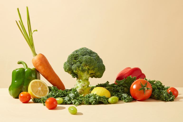 fdg6ghf-1758210210 Advertising photo for product made from fresh vegetable ingredient, was taken from front angle over yellow background. Various types of organic vegetable spread evenly on table with lettuce below
