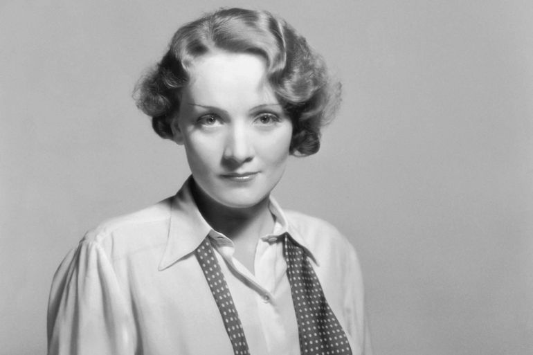 1932: Marlene Dietrich (1901 - 1992) casually dressed in shirt and loosened tie. (Photo by Eugene Robert Richee/John Kobal Foundation/Getty Images)