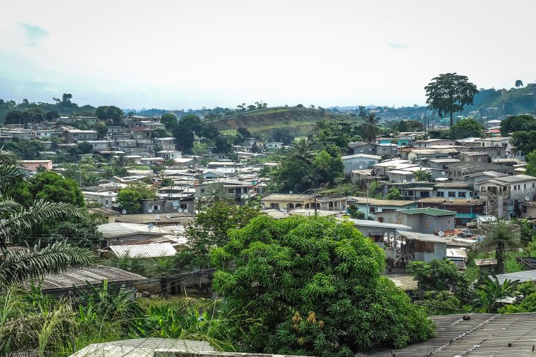 Panoramic view with parabolic tin roofs and palm trees of the African city of Libreville, capital of Gabon