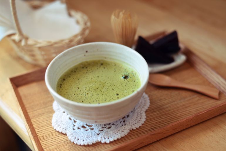 Organic Japanese hot green tea and Japanese wire whisk made of bamboo