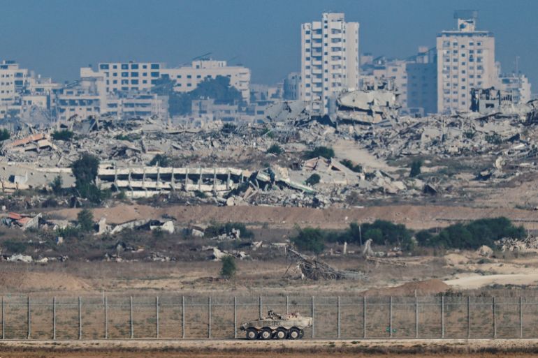 An Armored Personnel Carrier manoeuvres along the Israeli side of the border, as destruction in Gaza is seen in the background, in Israel September 16, 2025. REUTERS/Amir Cohen