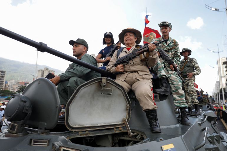 reuters_68d77ce7-1758952679 Members of the Bolivarian Militia, National Armed Forces and people on top of a tank take part in a rally of the Bolivarian National Militia in support of Venezuelan President Nicolas Maduro, amid rising tensions with the United States, in Caracas, Venezuela September 23, 2025. REUTERS/Leonardo Fernandez Viloria