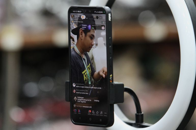 shutterstock_2326754065-1756632374 Live streaming sale of wedding dresses through the social media platform TikTok at the Beringharjo market, Yogyakarta, Indonesia on July 4, 2023.