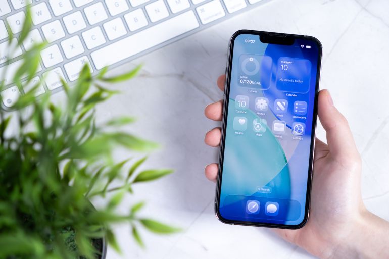 shutterstock_2640126173-1753003343 Poznan, Poland - June 10, 2025: A hand presents a smartphone screen displaying the innovative New iOS 26 operating system with a Liquid Glass design, enhancing modern digital productivity; Shutterstock ID 2640126173; purchase_order: AJA; job: ; client: ; other: