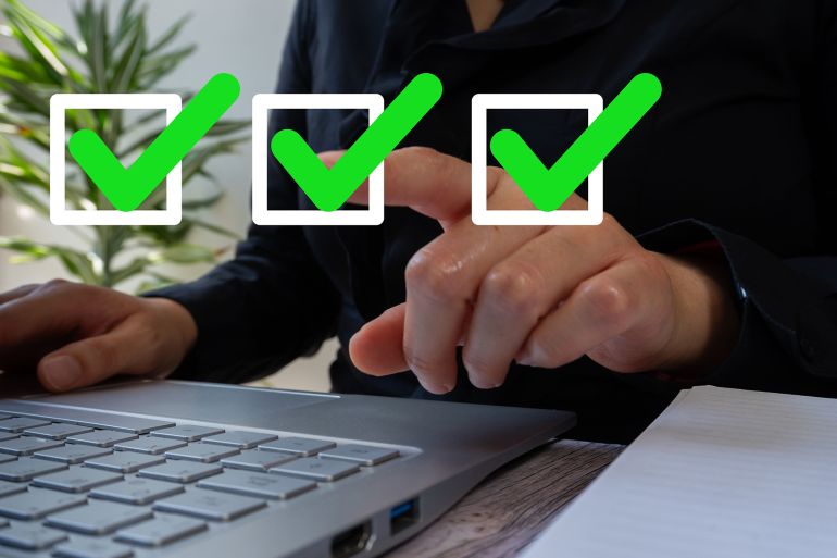 4y6tfh-1759752816 A businesswoman working on a laptop points to a green check mark icon in a square frame. Authorization concept