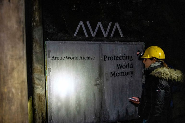 LONGYEARBYEN, NORWAY - AUGUST 26: Tourist stands next to the Arctic World Archive (AWA) that will include the GitHub Arctic Code Vault, in former coal mine number 3, on Svalbard archipelago on August 26, 2020 in Longyearbyen, Norway. The GitHub Arctic Code Vault will be a repository of all open source software in the GitHub system from February 2, 2020, and preserve it there on data storage media to last at least 1,000 years. Svalbard archipelago is located approximately 1,200km north of the Arctic Circle and is also home to the Svalbard Global Seed Vault. (Photo by Maja Hitij/Getty Images)