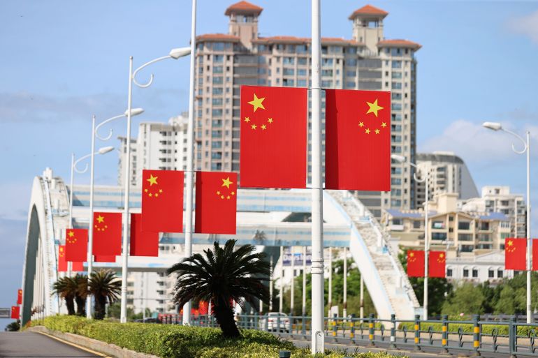 SANYA, CHINA - SEPTEMBER 27: The road is adorned with national flags as National Day, Mid-Autumn Festival holidays approach on September 27, 2025 in Sanya, Hainan Province of China. As China's National Day and Mid-Autumn Festival both approach, festive decorations have been set up across cities in China, creating a lively festive atmosphere. (Photo by Yuan Yongdong/VCG via Getty Images)
