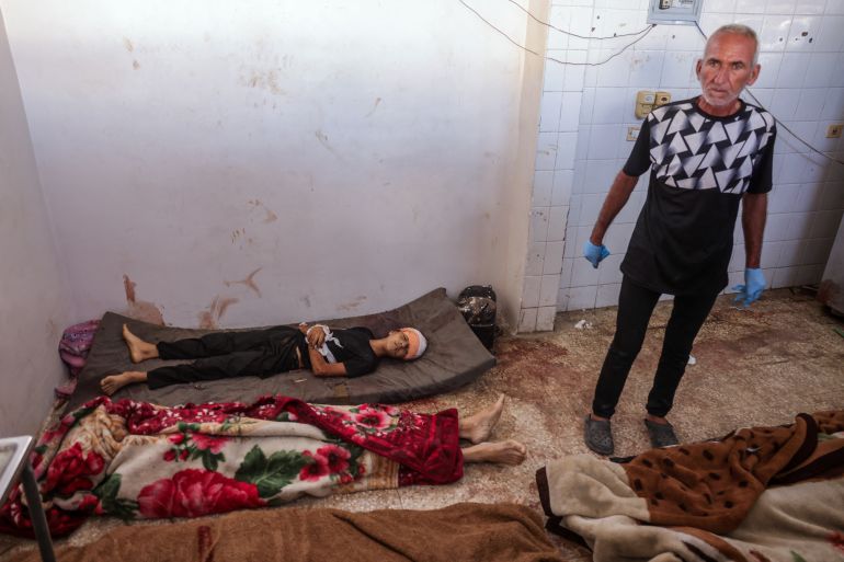 afp_68dcf1f84519-1759310328 EDITORS NOTE: Graphic content / A mortuary worker stands by the bodies of people killed in Israeli strikes, at the morgue of al-Aqsa Martyrs hospital in Deir el-Balah in the central Gaza Strip, on October 1, 2025.