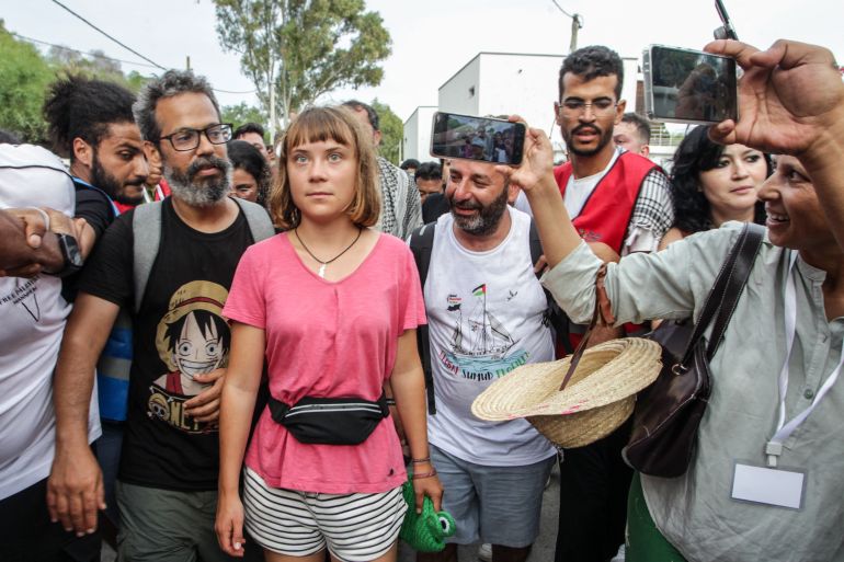 (FILES) Swedish climate activist Greta Thunberg walks with a crowd of pro-Palestinian activists that arrived to greet the Global Sumud Flottila at the port of the village of Sidi Bou Said on September 7, 2025.