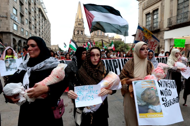 Women perform a piece about children killed in Gaza during a demonstration demanding an end to attacks on the Gaza Strip and Palestinian territories as part of a national protest in Guadalajara, Mexico on October 7, 2025.