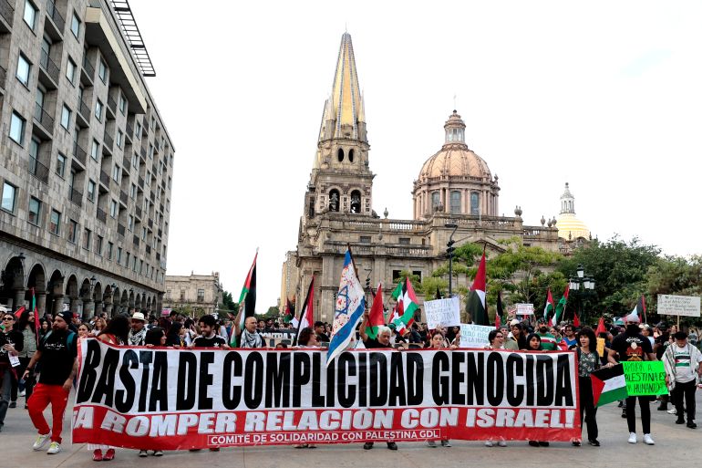 Demonstrators show a banner that reads "No more genocidal complicity, break relations with Israel" during a demonstration demanding an end to attacks on the Gaza Strip and Palestinian territories as part of a national protest in Guadalajara, Mexico on October 7, 2025.