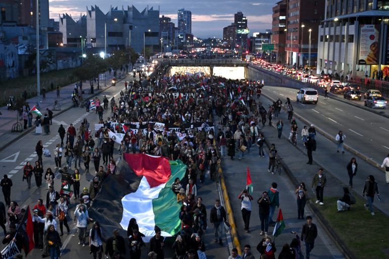 Demonstrators hold a giant Palestinian flag as they take part in a march in Bogota on October 7, 2025, on the second anniversary of the deadly Hamas-led attack on Israel which sparked a retaliatory offensive in Gaza.