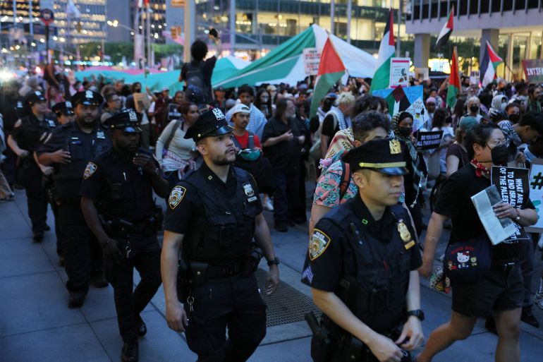 NEW YORK, NEW YORK - OCTOBER 07: NYPD officers walk alongside pro-Palestinian activists as they march along Sixth Avenue to protest the war in Gaza on the October 7th Anniversary on October 07, 2025 in New York City. The protest was held on the second anniversary of Hamas’s Oct. 7, 2023 attack on Israel that killed about 1,200 people and saw 251 hostages taken. Forty-eight hostages remain in Gaza. Gaza’s health authorities say more than 67,000 Palestinians have been killed in a war that has also displaced roughly 2 million people. Talks are underway in Egypt on a ceasefire and hostage deal. Michael M. Santiago/Getty Images/AFP (Photo by Michael M. Santiago / GETTY IMAGES NORTH AMERICA / Getty Images via AFP)