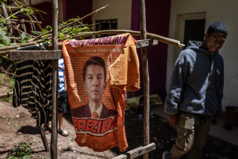 A student at the University of Ankatso walks past a t-shirt depicting Madagascar’s President Andry Rajoelina drying as laundry in a deteriorating student dormitory affected by recurring water and power shortages in Antananarivo, on October 8, 2025.